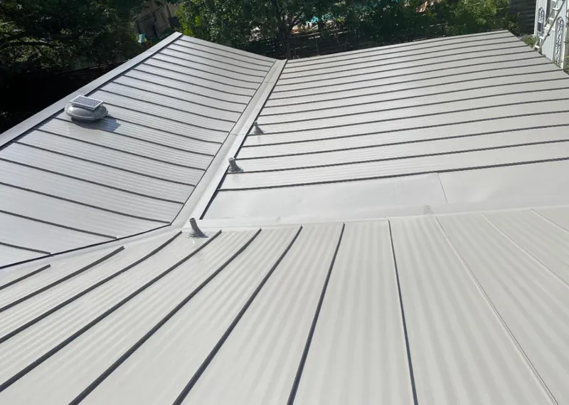 Solar attic fan installed on a metal roof for Roof Ventilation in Hastings-on-Hudson